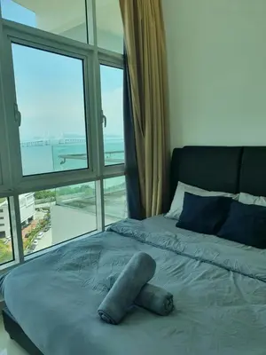 a bed in a room with a large window at Southbay Seaview Condo A2 10minQueensbay 10minSpice in Bayan Lepas