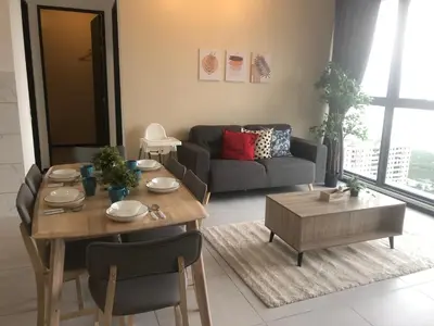 a living room with a table and a couch at Urban Suite Condominium By Blue Sky Holidays in Jelutong