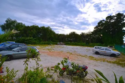 two cars are parked in a flooded street at Yew Boutique Hotel in Teluk Intan