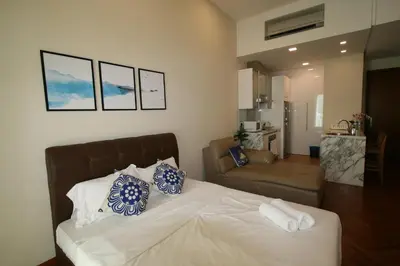 a bedroom with a bed and a living room at Profolio @ Straits Quay in George Town