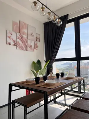 a dining room with a table and a large window at Georgetown Urban Family & Baby-Friendly Home with Skypool Seaview in Jelutong