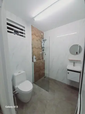 a bathroom with a shower and a toilet and a sink at Yarra SP Homestay in Sungai Petani