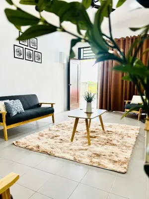 a living room with a couch and a coffee table at Casa Kita Homestay in Bandar Baharu