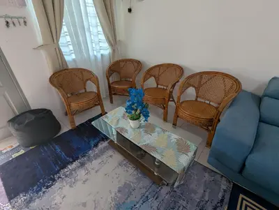 a living room with a couch and chairs and a table at HOMESTAY IBUNDA Sabak Bernam in Sabak Bernam