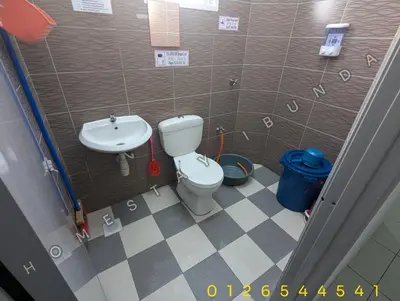 a small bathroom with a toilet and a sink at HOMESTAY IBUNDA Sabak Bernam in Sabak Bernam