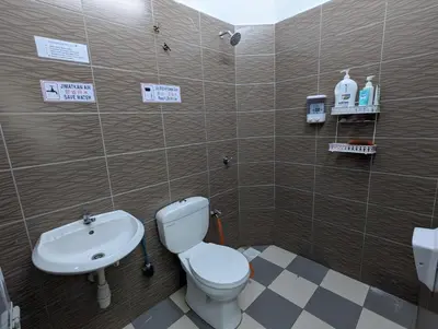 a bathroom with a toilet and a sink at HOMESTAY IBUNDA Sabak Bernam in Sabak Bernam