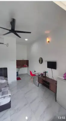 a living room with a ceiling fan and a couch at D'SQ Homestay in Tanjung Karang