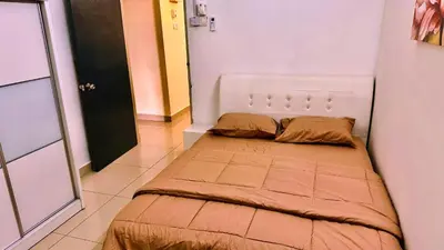 a small bedroom with a bed in a room at Cozy Homestay in Ipoh