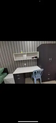 an office with a desk and a bed in a room at Zaf's Stay in Kampong Malim Nawar