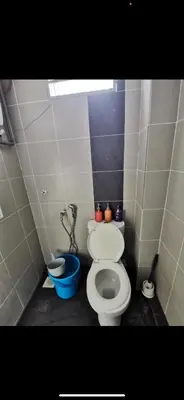 a bathroom with a toilet and a blue bowl at Zaf's Stay in Kampong Malim Nawar