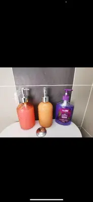 a bathroom with two bottles of soap and a sink at Zaf's Stay in Kampong Malim Nawar