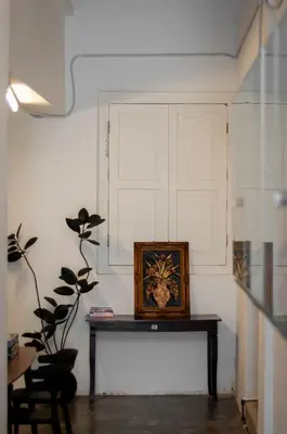 a room with a table with a picture on the wall at Aayu Seckchuan - 3 mins walk to Love Lane in George Town