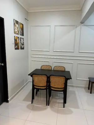 a black table and two chairs in a room at Namel Homestay Taiping in Kampong Jana