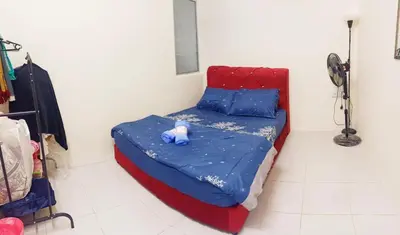 a small bed in a room with a teddy bear on it at Ceq Atiah Homestay in Seri Iskandar