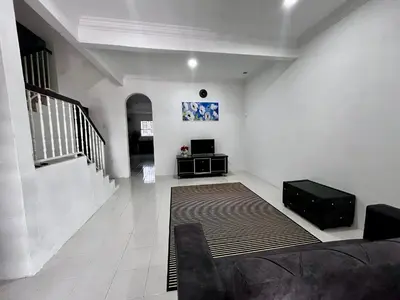 a living room with a couch and a television at DH Homestay in Sungai Petani
