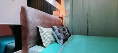a bedroom with a bed with pillows on it at A boutique Warm falim home in Kampong Pasir Puteh
