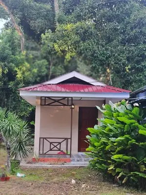 a small house with a red roof and a door at Zue Rra Hidden Retreat in Kampong Kuala Chegar