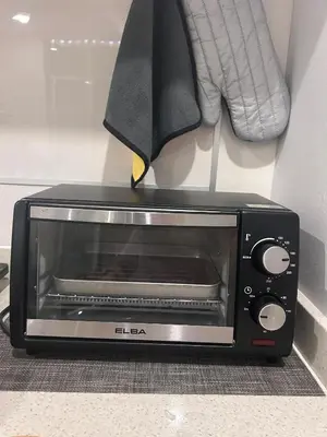 a toaster oven with a knife sticking out of it at City View & Sea View Mansion One Gleneagles Gurney Komtar George Town by Cozy Cottage Haven in George Town