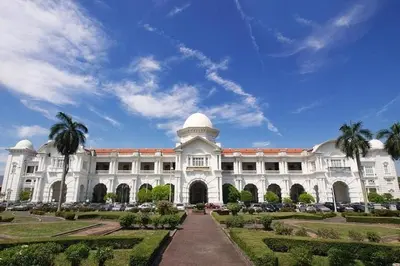 a large white building with palm trees in front of it at IPOH Sky Garden Residences, 31200 Chemor Ipoh in Chemor