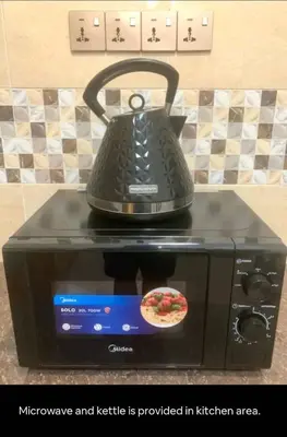 a microwave with a tea kettle on top of it at 1Pax-2Pax Single Room in Bukit Mertajam Alma Impian in Juru