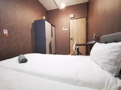 a bedroom with a white bed and a wooden wall at 1Pax Single Room in Bukit Mertajam Alma Impian in Juru