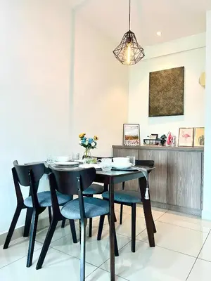 a dining room with a table and chairs at Arena guesthouse in Bayan Lepas