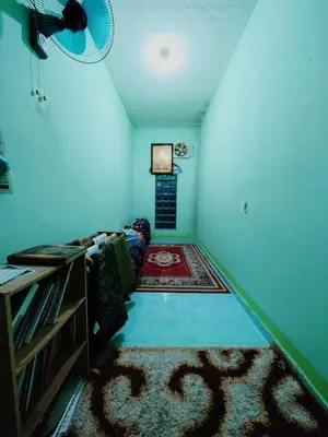 a living room with a couch and a rug at Homestay Bendang Becah in Baling