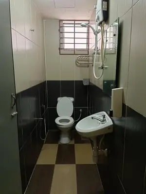 a bathroom with a toilet and a sink at Casavilla Hotel in Taiping