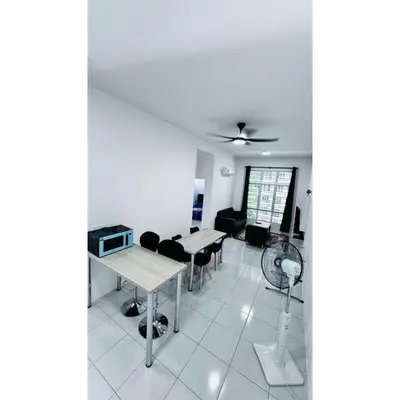 a living room with a table and chairs and a fan at Ipoh Anderson Khan Residence by Khan in Ipoh