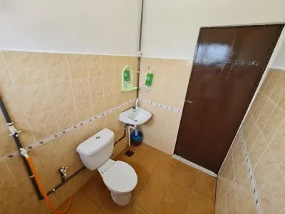 a bathroom with a toilet and a sink at Azam Homestay in Seri Manjung