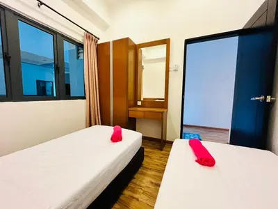 two beds in a room with red pillows on them at Nova Sunrise & Mountain view Hilltop in Cameron Highlands in Brinchang