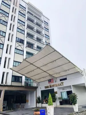 a large white building with awning in front of it at Nova Sunrise & Mountain view Hilltop in Cameron Highlands in Brinchang