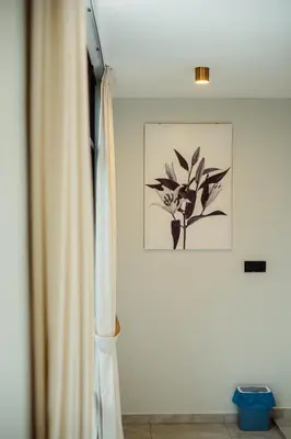 a room with a curtain and a picture on the wall at Ipoh Modern Luxury House 4B3B 14 pax in Kampong Baharu Ampang