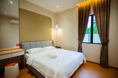 a bedroom with a bed with a stuffed animal on it at Ipoh Modern Luxury House 4B3B 14 pax in Kampong Baharu Ampang