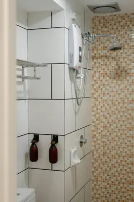 a bathroom with a shower and a toilet in it at Modern Minimalist Home Retreat near Lake Garden in Taiping