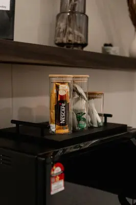 a container on top of a shelf on a refrigerator at Modern Minimalist Home Retreat near Lake Garden in Taiping