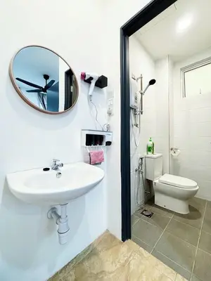 a bathroom with a sink and a mirror and a toilet at Trace Cozy Place in Teluk Intan