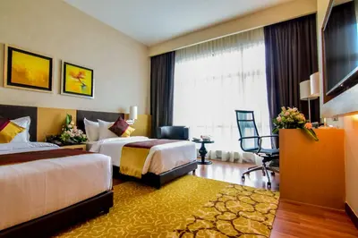 a hotel room with two beds and a large window at The Light Hotel Penang in Perai