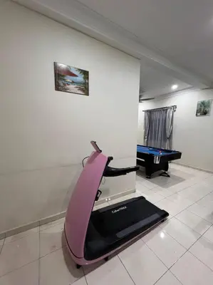 a room with a treadmill and a pool table at Family choice Ling53 in Sitiawan