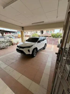 a white car parked inside of a garage at Family choice Ling53 in Sitiawan