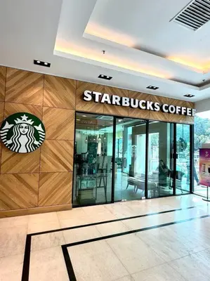 a starbucks coffee shop with a sign on the wall at Mansion One Modern 5pax walking distance Gleneagles Hospital Gurney Plaza in George Town