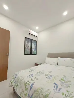 a white bedroom with a bed and a window at Manhattan Suites Ipoh in Kampong Makam