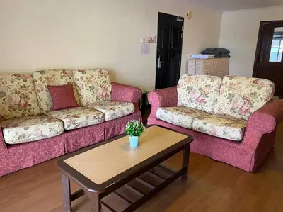 a living room with two couches and a coffee table at Brinchang Cameron 2R2B 10 paxs Copthorne KeaFarm #15407 in Brinchang