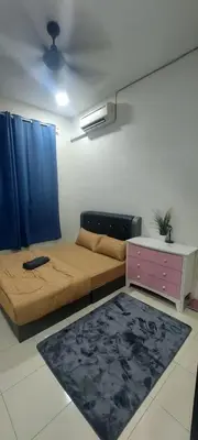 a living room with a bed and a dresser and a couch at Doleena's Homestay in Sitiawan