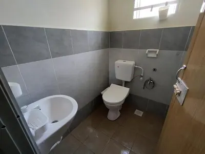 a bathroom with a toilet and a tub and a sink at Doleena's Homestay in Sitiawan