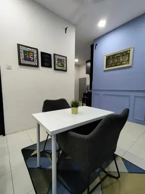 a white table and two chairs in a room at Doleena's Homestay in Sitiawan