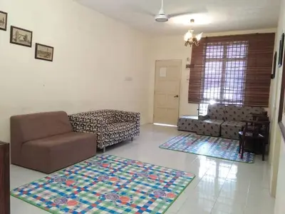 a living room with a couch and two rugs at M4R Homestay Gua Musang in Kampong Batu Papan