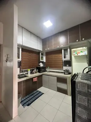 a kitchen with stainless steel appliances and brown cabinets at Melati Homestay Cameron Highland in Tanah Rata