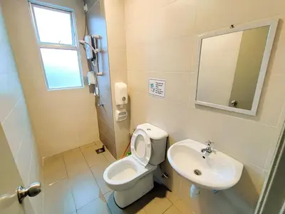 a bathroom with a toilet and a sink at Somer GoldenHills Cameron Highlands Free Wi-Fi in Brinchang