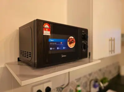 a microwave oven sitting on a shelf in a kitchen at Helena Homes - Premium Cozy Ipoh Homestay in Kampong Simee